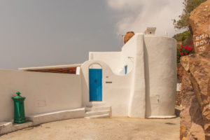 Sicily - Sunny impressions of the Aeolian Islands, also known as Aeolian Islands or Isole Eolie: Lipari, Stromboli, Salina, Vulcano, Panarea, Filicudi and Alicudi. Typical white house facade on Panarea. Sicily - Sunny impressions of the Aeolian Islands, also known as Aeolian Islands or Isole Eolie: Lipari, Stromboli, Salina, Vulcano, Panarea, Filicudi and Alicudi. Typical white house facade on Panarea.